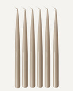 Set of six PLAMYA taper candles in Sand Ash (grey) shade on a white background