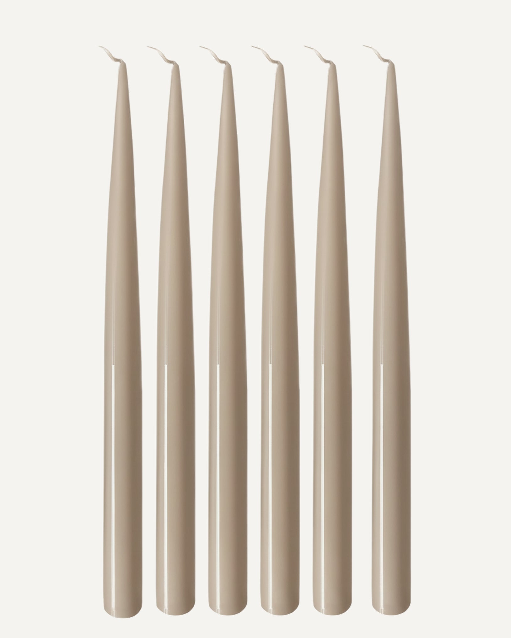 Set of six PLAMYA taper candles in Sand Ash (grey) shade on a white background