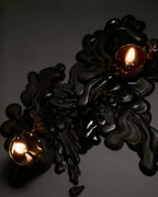 Black candles wax melted on black background 